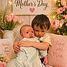 baby, toddler, child, hugging, mother_day, flowers, pink, cushion, love_message, decorations, lights, portrait, family, cute, indoor, cozy, smile, person, clothing, wooden_wall