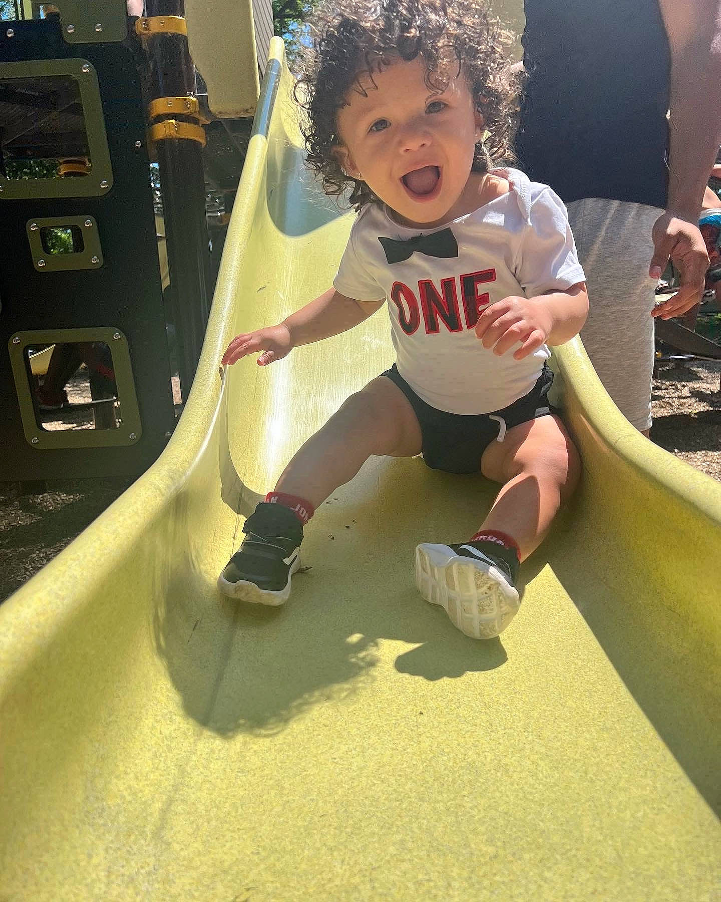 Isaias is registered to the contest to win money with this photo: child, cool, flooring, fun, hairstyle, happy, human_leg, knee, leisure, outdoor_play_equipment, person, playground, playground_slide, recreation, sandal, shorts, shoulder, sportswear, t_shirt, thigh