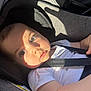 baby, child, car_seat, seatbelt, white_shirt, sunlight, shadow, face, eyes, skin, infant, sitting, safety, straps, car, interior, portrait, cute, young, closeup