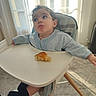 toddler, child, high_chair, bread, food, indoor, sunlight, curious, expression, clothing, socks, floor, window, curtains, tray, seat, person, baby, legs, home