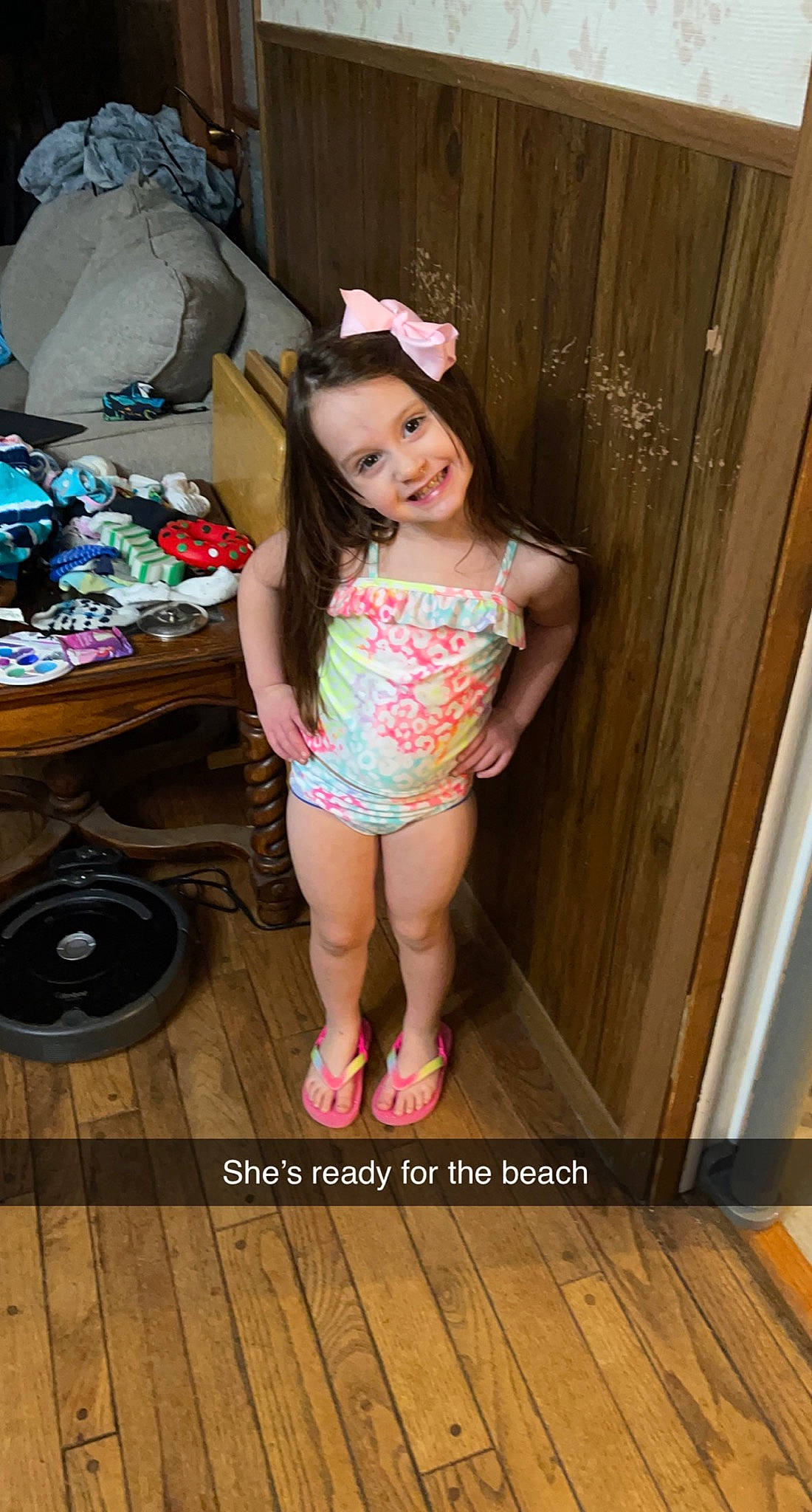 Brooklyn is registered to the contest to win money with this photo: floor, flooring, fun, happy, hardwood, hat, human_leg, joy, leg, leisure, magenta, person, pink, sandal, shoe, shorts, smile, standing, t_shirt, thigh