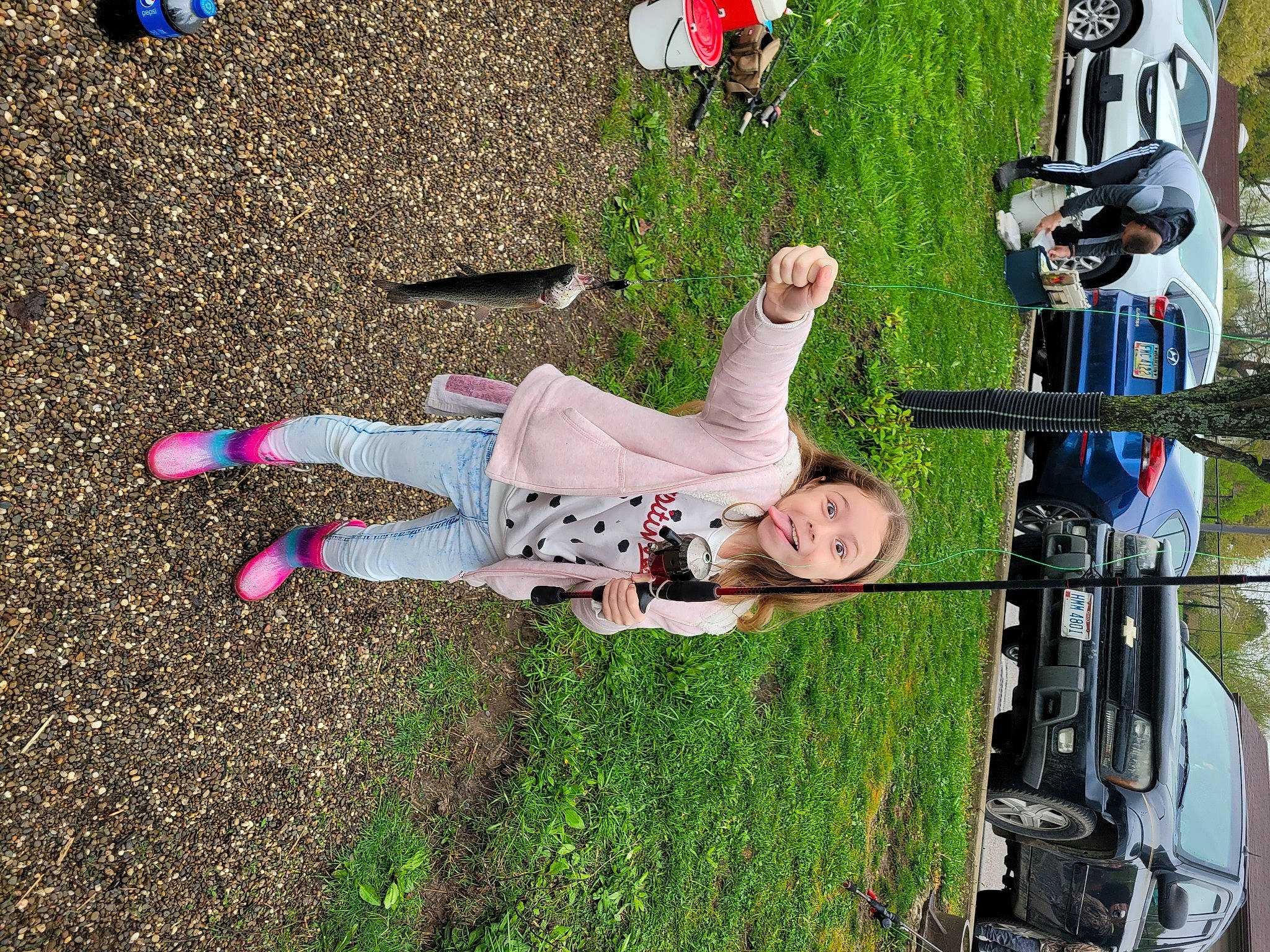 Briella is registered to the contest to win money with this photo: automotive_exterior, car, family_car, fun, grass, happy, landscape, leisure, motor_vehicle, people_in_nature, person, plant, recreation, shadow, smile, tire, tree, vehicle, vehicle_door, walking_shoe