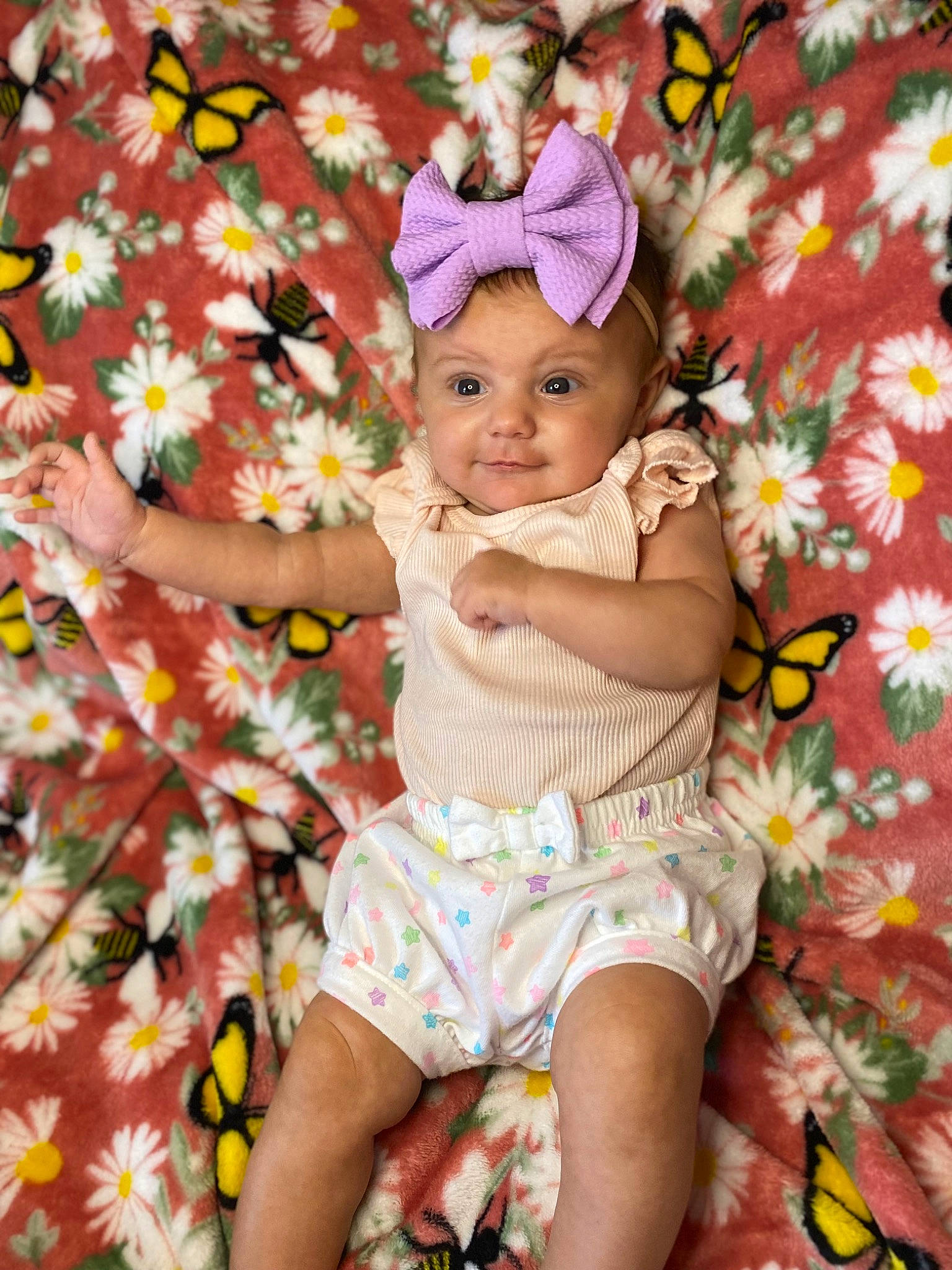 Nevaeh joined the competition — help win amazing prizes! baby, baby_toddler_clothing, cap, child, fun, grass, happy, headband, headwear, leaf, magenta, pattern, people_in_nature, person, petal, pink, shorts, skin, smile, textile