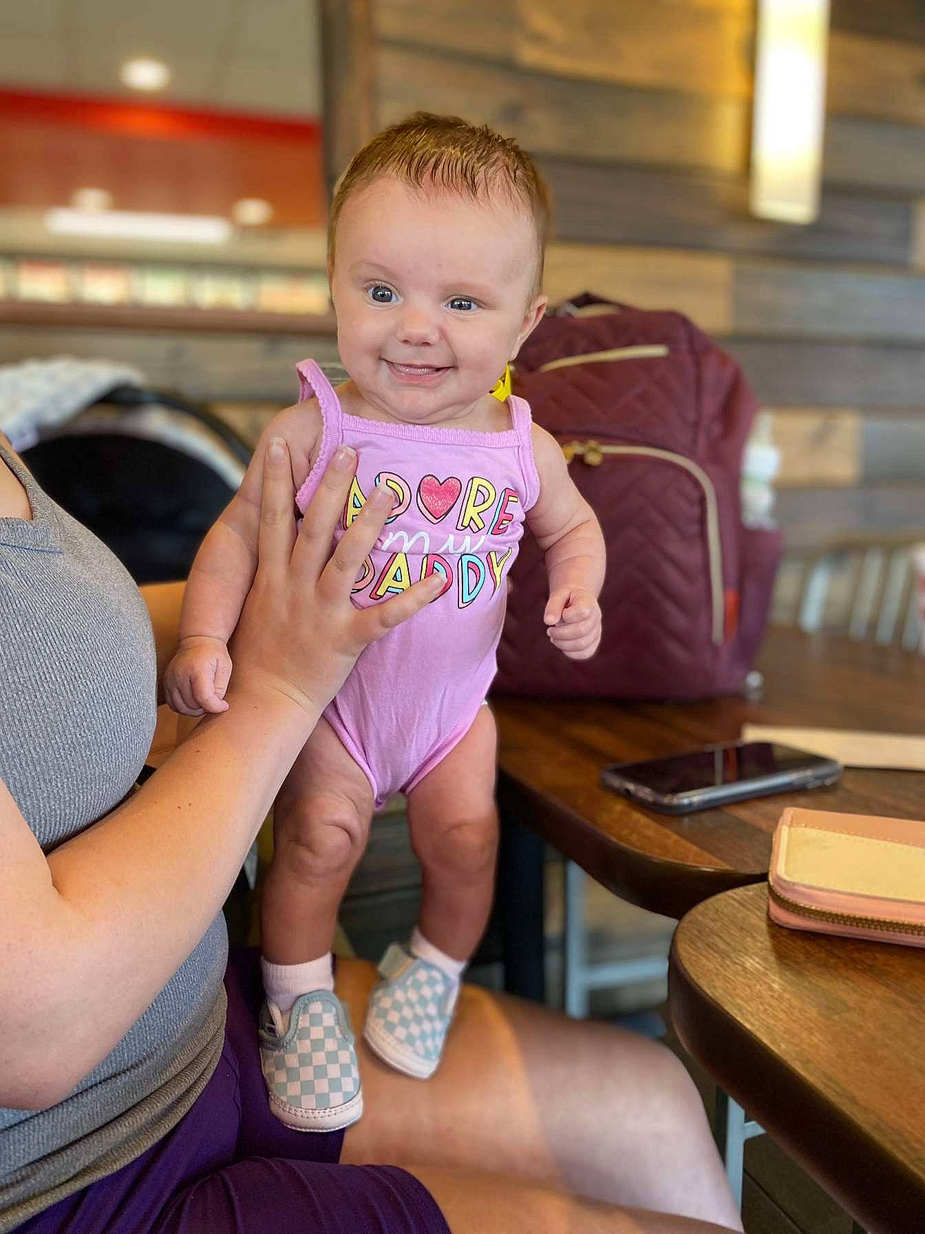 Nevaeh is registered to the contest to win money with this photo: baby, baby_toddler_clothing, child, fun, happy, human_leg, joy, knee, lap, leg, leisure, person, shoulder, sitting, skin, sleeve, smile, sock, table, thigh