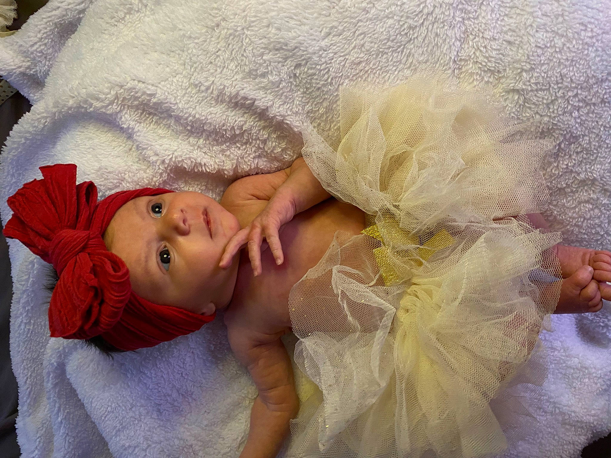 Nevaeh is registered to the contest to win money with this photo: arm, baby, blond, child, comfort, eye, eyelash, hair, hand, happy, head, headgear, headpiece, headwear, human_body, iris, lip, neck, person, skin