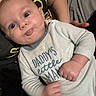 Austin is registered to the contest to win money with this photo: baby, infant, onesie, clothing, person, child, blue_eyes, hand, face, cute, expression, indoor, adult_arm, sitting, casual, comfortable, closeup, skin, mouth, puffy_cheeks