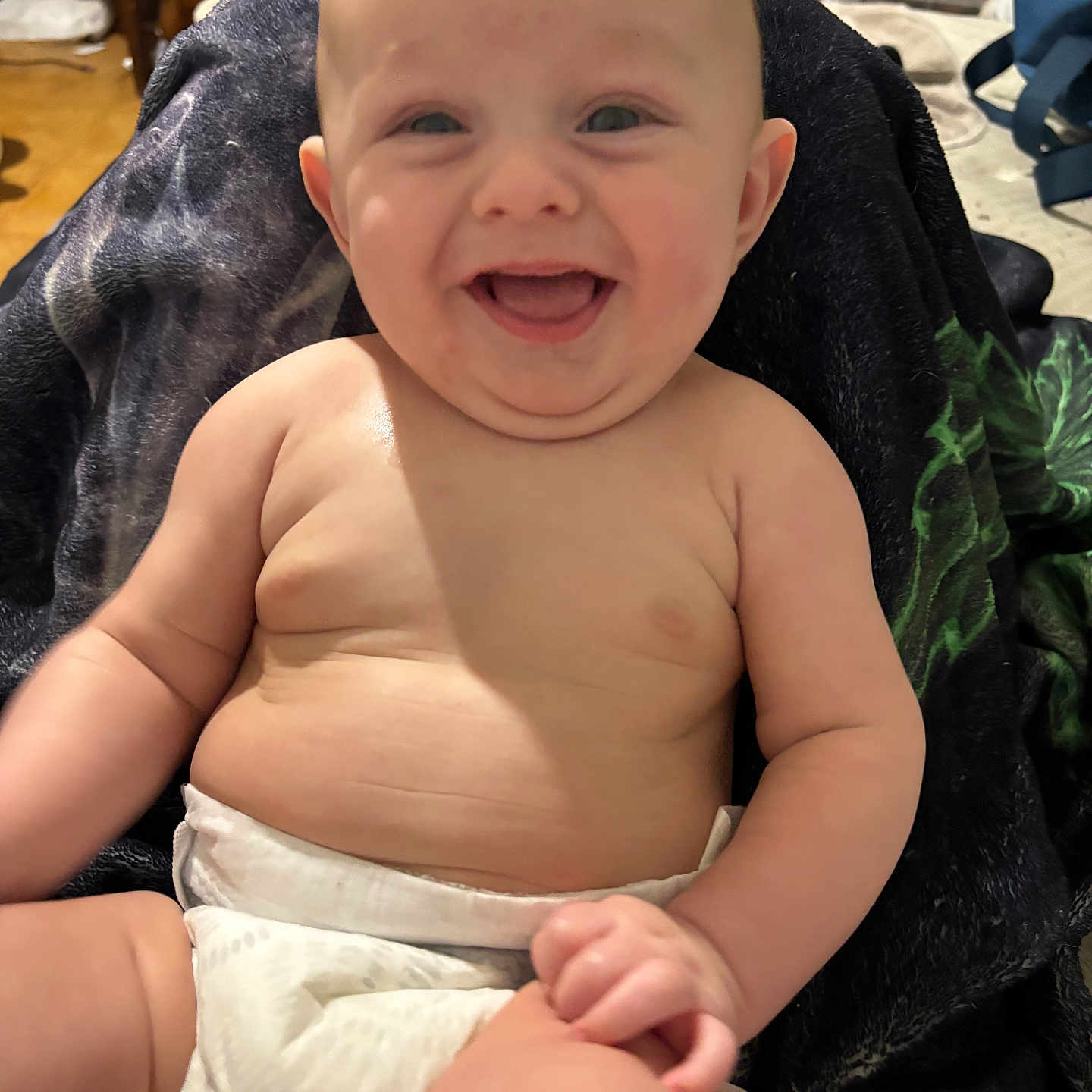 Austin joined the competition — help win amazing prizes! baby, smiling, diaper, happy, infant, child, skin, cute, chubby, face, person, sitting, indoors, blanket, furniture, head, expression, joy, comfort, home