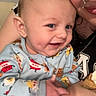 baby, child, adult, smile, pajamas, food_prints, dimples, face, hand, arm, piercing, necklace, indoor, person, holding, happy, cute, closeup, affection, bond
