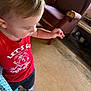 Johnathan joined the competition — help win amazing prizes! armchair, blue_pattern, candid, carpet, cartoon_print, casual_clothing, child, curly_hair, floor, furniture, home_interior, indoor, looking_down, person, reaching_out, red_shirt, shoe, toddler, worn_furniture, young_child