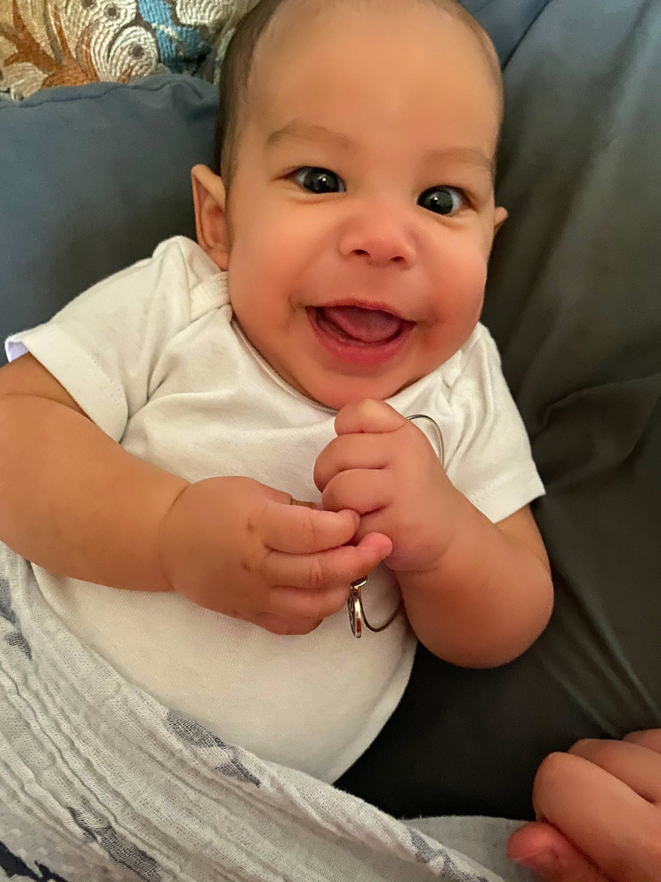 Reid is registered to the contest to win money with this photo: baby, baby_toddler_clothing, cheek, comfort, eye, eyebrow, eyelash, facial_expression, finger, gesture, hand, happy, head, iris, joy, lip, nose, person, skin, sleeve