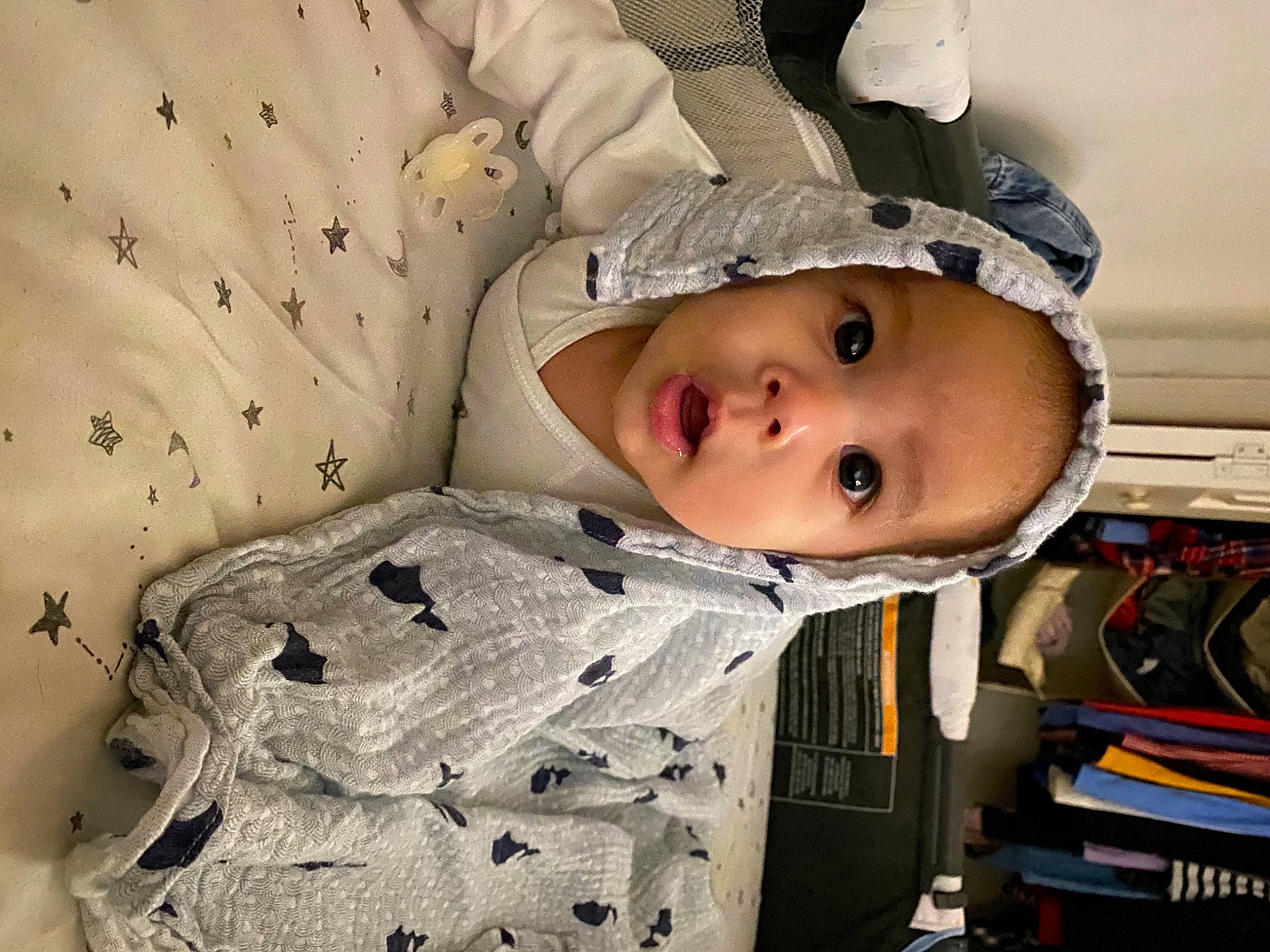 Reid is registered to the contest to win money with this photo: baby, baby_products, baby_safety, baby_toddler_clothing, bedding, cheek, child, comfort, eye, face, facial_expression, head, linens, military_camouflage, outerwear, pattern, person, room, sitting, sleeve