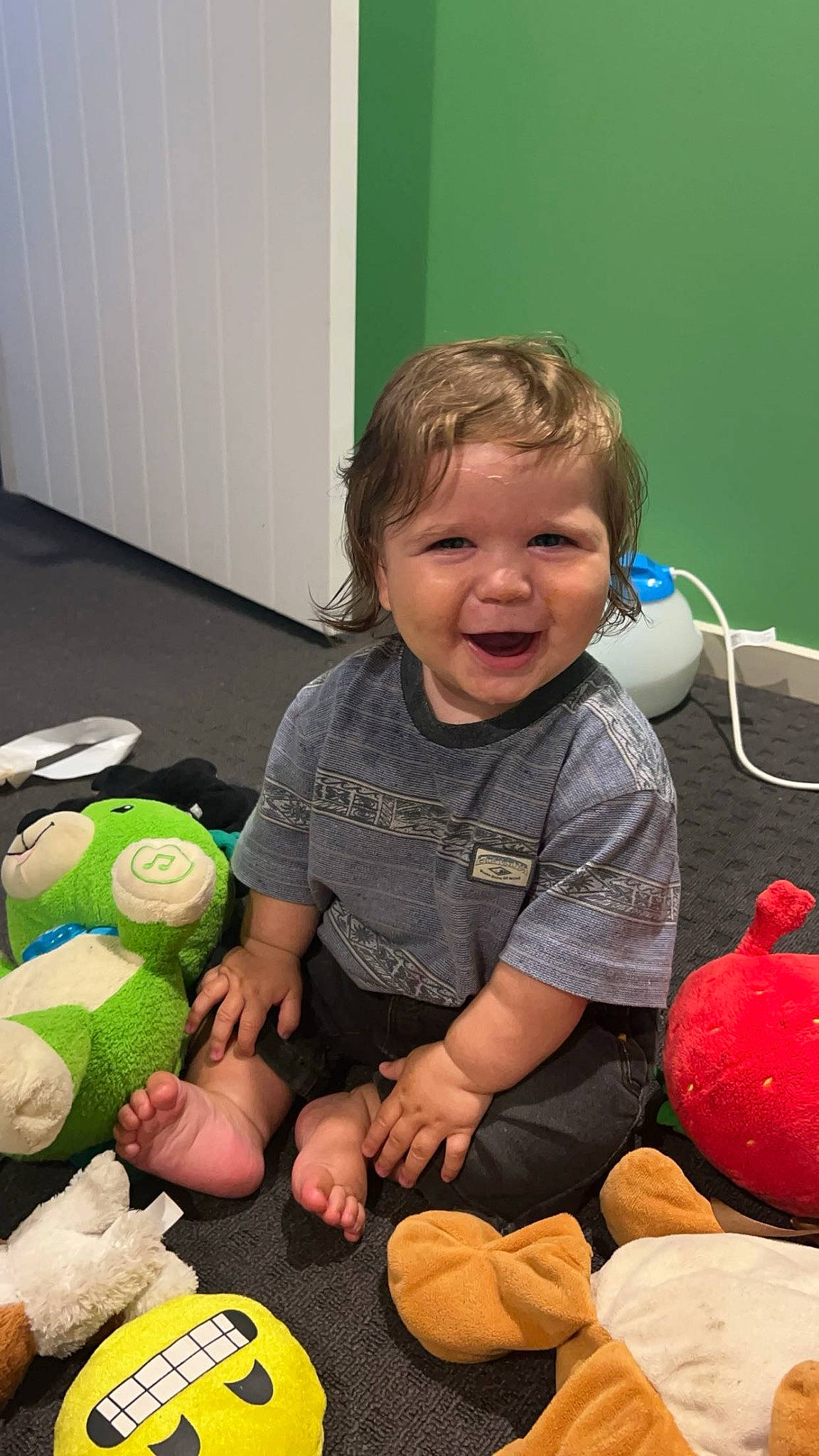 Madix is registered to the contest to win money with this photo: baby, baby_toddler_clothing, baby_toys, carmine, child, flooring, fun, happy, holiday, people, person, play, plush, room, sitting, smile, sock, stuffed_toy, t_shirt, toddler