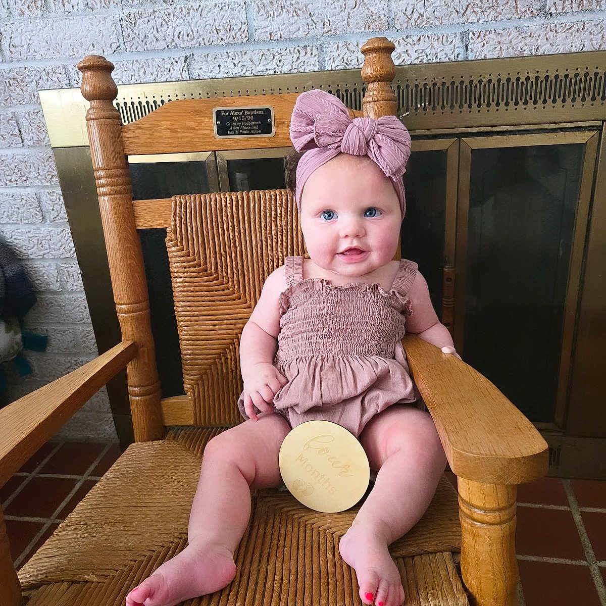 Evelyn joined the competition — help win amazing prizes! baby, blue_eyes, brick_wall, child, cozy, cute, fireplace, floor_tiles, four_months_sign, happy, headband, indoor, infant, pink_bow, plush, portrait, sitting, smiling, wood, wooden_chair