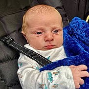 Rhyatt joined the competition — help win amazing prizes! baby, infant, child, blanket, blue_blanket, car_seat, straps, onesie, clothing, hand, face, head, expression, indoor, soft_texture, fabric, person, newborn, portrait, seated