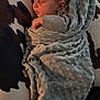 baby, sleeping, blanket, pillow, pattern, texture, infant, peaceful, resting, cozy, soft, wrapped, child, young, cute, portrait, indoor, comfort, relaxation, closeup