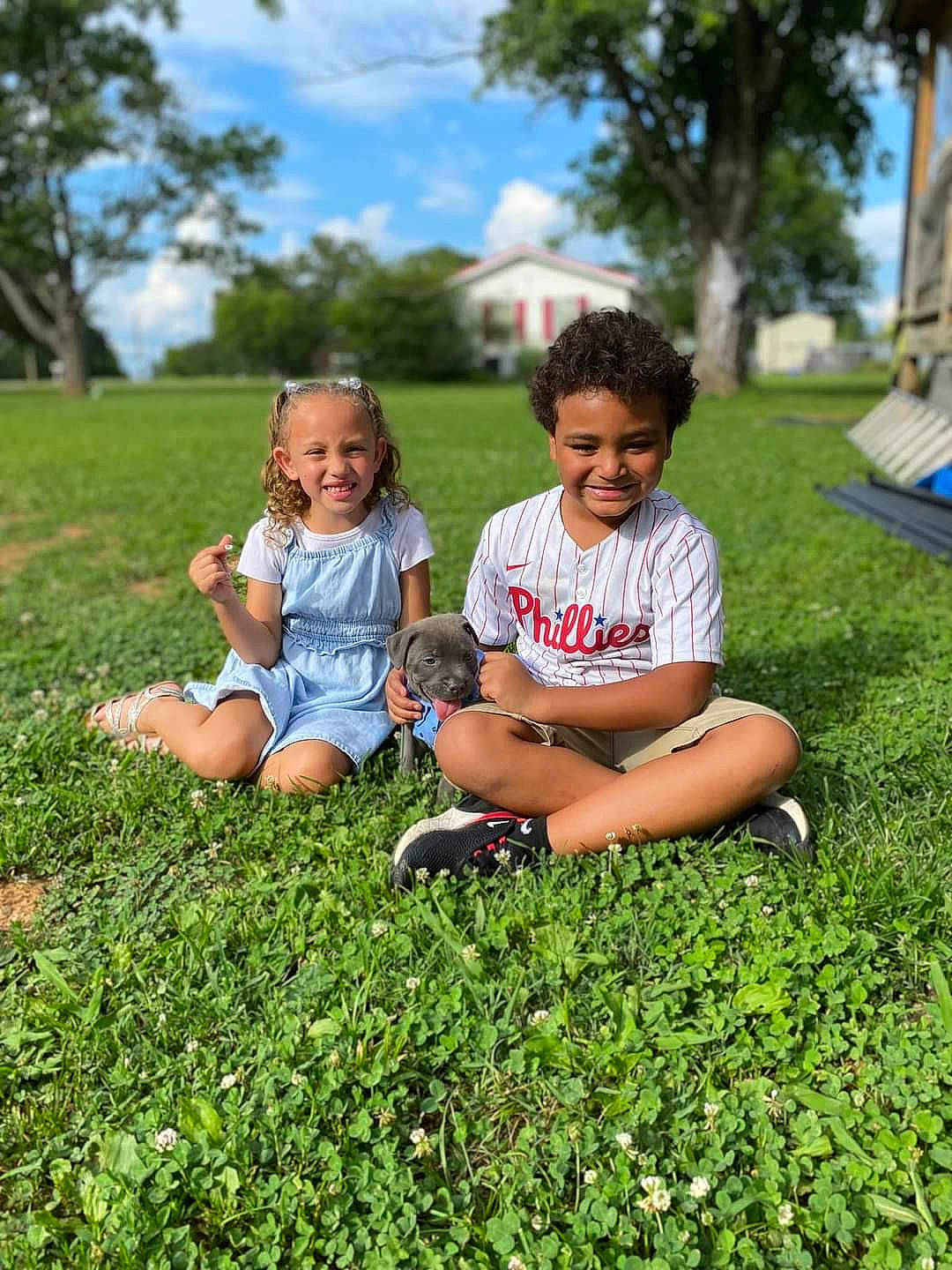 Brookelynn is registered to the contest to win money with this photo: child, cloud, foot, fun, grass, grassland, groundcover, happy, joy, leisure, meadow, people_in_nature, person, plant, recreation, shorts, sitting, sky, summer, t_shirt