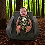 armchair, baby, camouflage, child, clothing, cute, face, footwear, forest, greenery, happy, infant, leaf_litter, nature, nike, outdoor, portrait, sitting, smile, trees