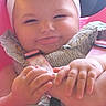 baby, child, bow, headband, smile, hand, foot, car_seat, seatbelt, clothing, cute, skin, portrait, infant, baby_girl, fingers, legs, indoors, closeup, happy