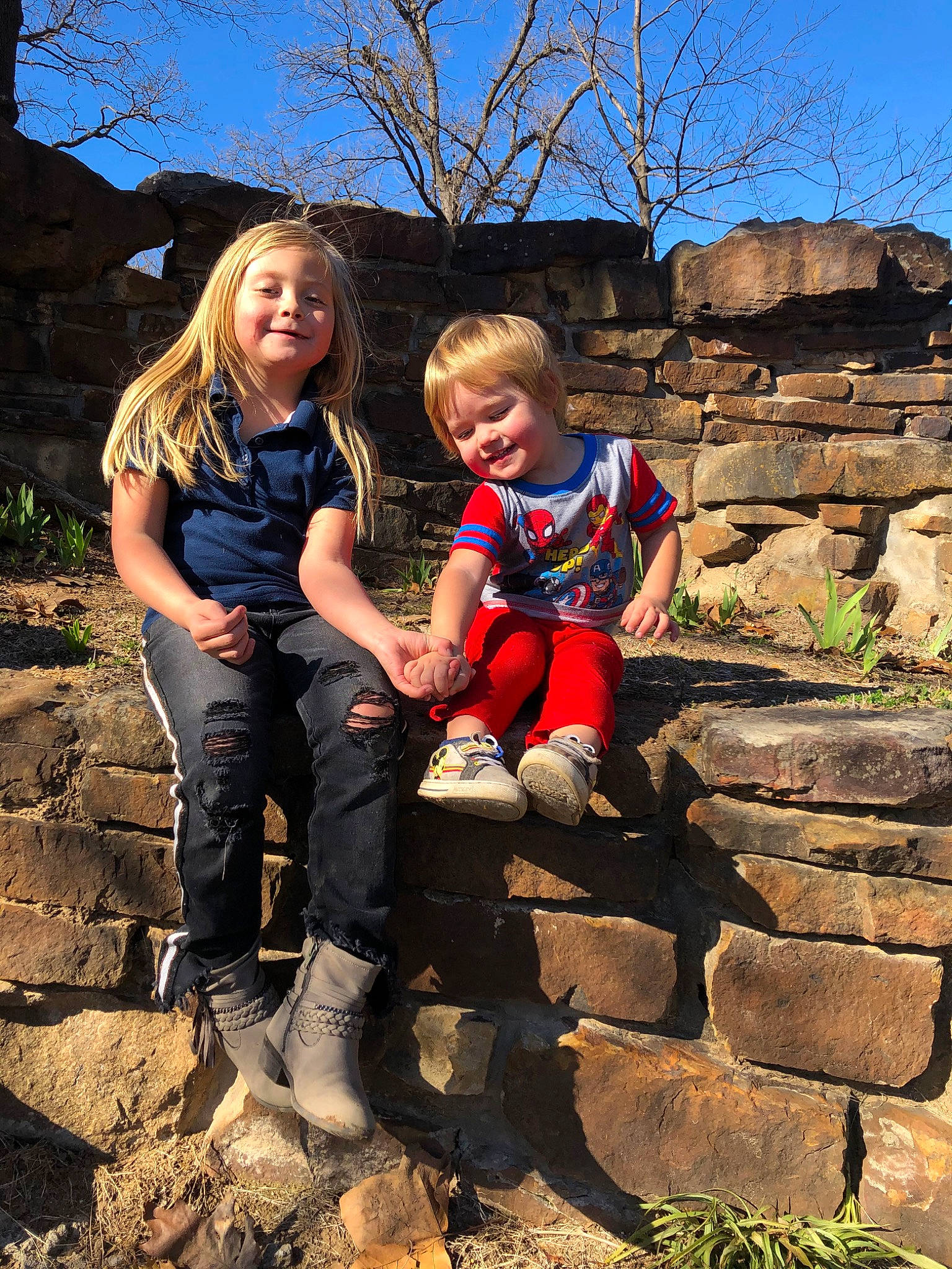 Dannie is registered to the contest to win money with this photo: child, family, fawn, fun, joy, leisure, people, person, photography, plant, recreation, rock, sibling, sitting, smile, spring, stone_wall, toddler, tourism, tree