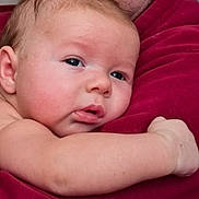 Ryan joined the competition — help win amazing prizes! baby, closeup, infant, skin, face, arm, red_fabric, resting, expression, portrait, child, cute, soft_skin, newborn, human, person, sleepy, comfort, indoor, young