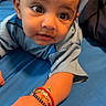 Aarav joined the competition — help win amazing prizes! baby, bed, bedding, blue_clothing, bracelet, child, closeup, cute, expression, eyes, face, hand, indoor, infant, lying_down, person, portrait, red_bracelet, skin, young_child