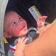 Oliver joined the competition — help win amazing prizes! arm, baby, car_seat, child, closeup, clothing, cute, face, hand, happy, indoor, infant, interaction, person, protective, safety, seatbelt, smiling, sunlight, young