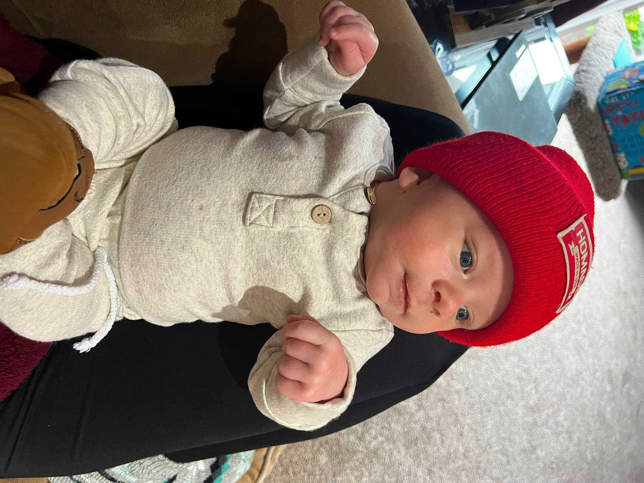 Thomas is registered to the contest to win money with this photo: baby, baby_toddler_clothing, box, cap, child, comfort, fun, gesture, hat, headgear, headwear, human_body, mouth, person, sitting, skin, sleeve, smile, thumb, toddler