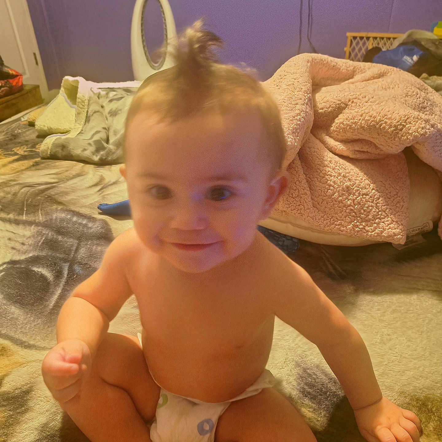 Brandon joined the competition — help win amazing prizes! baby, infant, child, sitting, smiling, portrait, face, topknot, diaper, bedroom, bed, blanket, bedding, indoor, home, purple_wall, furniture, cozy, happy, photography