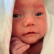 Emberlee is registered to the contest to win money with this photo: baby, blanket, bonnet, clothing, face, happy, hat, head, hood, newborn, person, photography, portrait, quilt, smile, towel