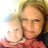 Serenity is registered to the contest to win money with this photo: baby, infant, mother, parent, child, adult, selfie, portrait, face, eyes, blonde_hair, smiling, cuddling, pink_clothing, indoor, close_up, family, headshot, photography, warm_lighting