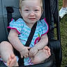 baby, child, toddler, stroller, smiling, portrait, outdoor, grass, sitting, harness, seatbelt, striped_shirt, pink_trim, bare_feet, infant, happy, face, photography, family, daylight