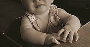 Serenity joined the competition — help win amazing prizes! baby, child, toddler, portrait, restaurant, dining, table, high_chair, sitting, reaching, hands, curious, neutral_expression, sepia, vintage, indoor, window, booth, background_people, text_overlay