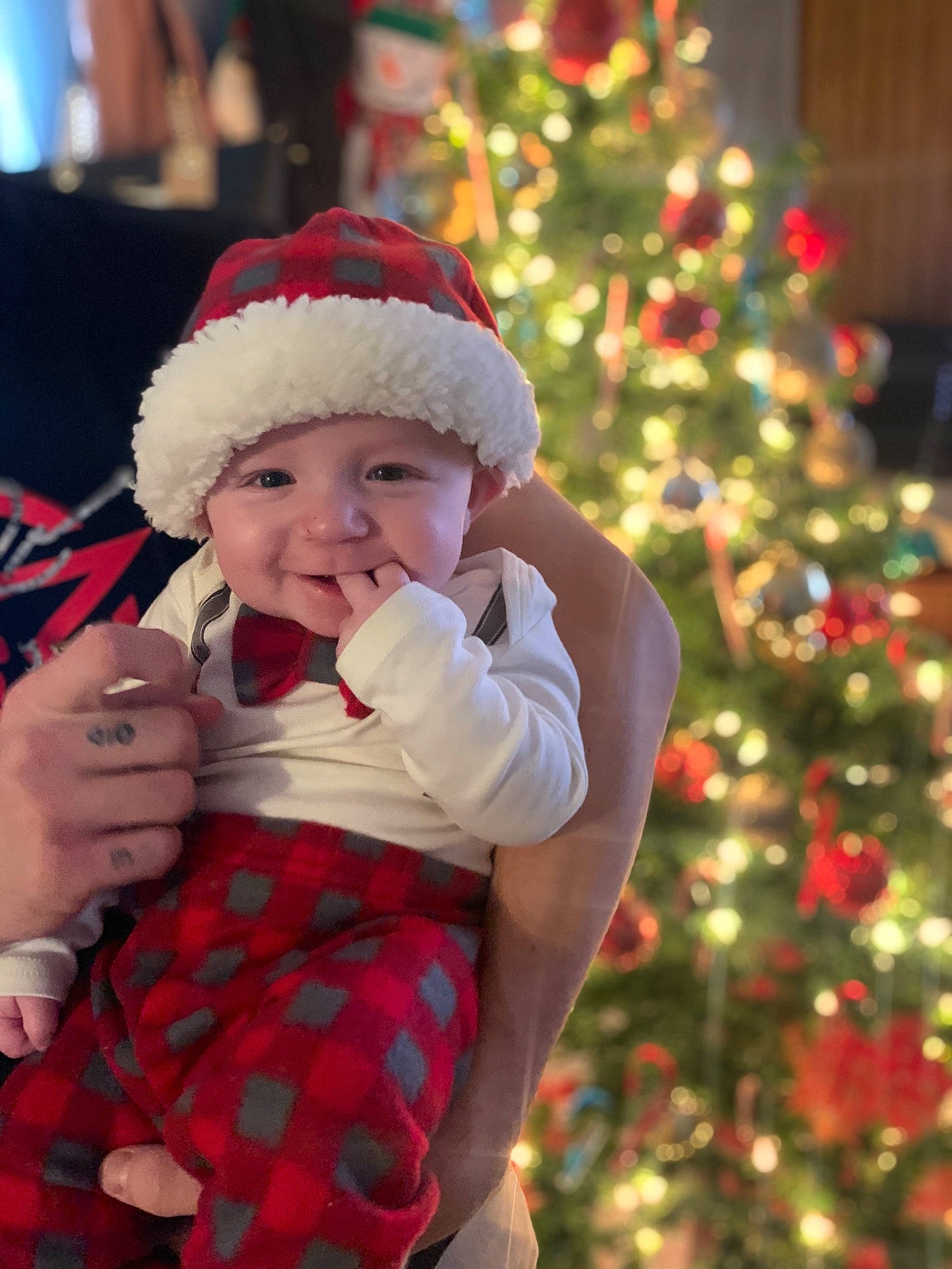 Killian joined the competition — help win amazing prizes! baby, baby_toddler_clothing, christmas, christmas_decoration, christmas_eve, christmas_lights, christmas_ornament, christmas_tree, event, fictional_character, hand, headwear, holiday, holiday_ornament, interior_design, joy, ornament, person, plaid, red