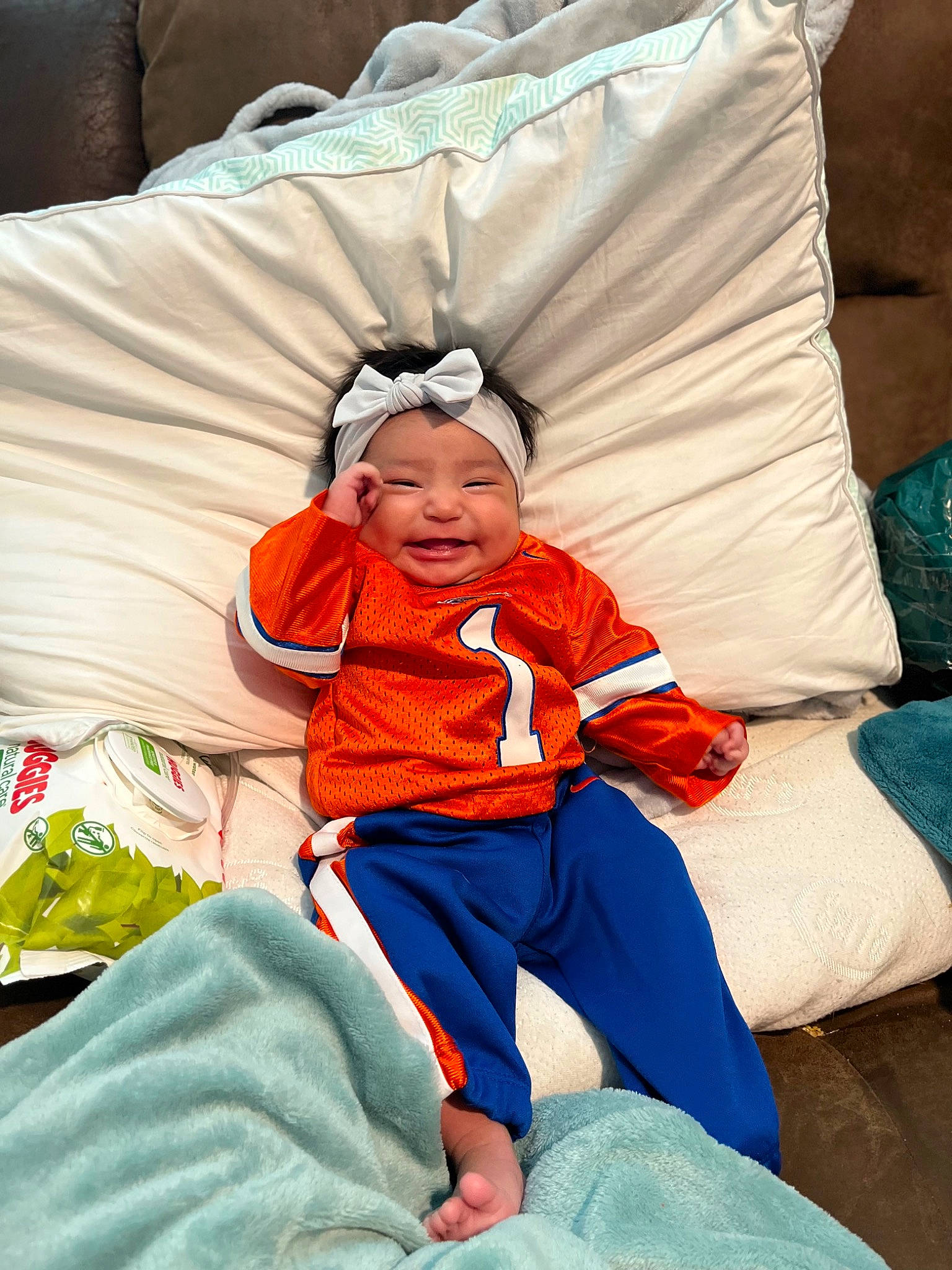 Leilah is registered to the contest to win money with this photo: baby, baby_products, baby_toddler_clothing, child, comfort, electric_blue, event, fashion_accessory, happy, headwear, lap, leisure, linens, person, recreation, sitting, throw_pillow, toddler, winter