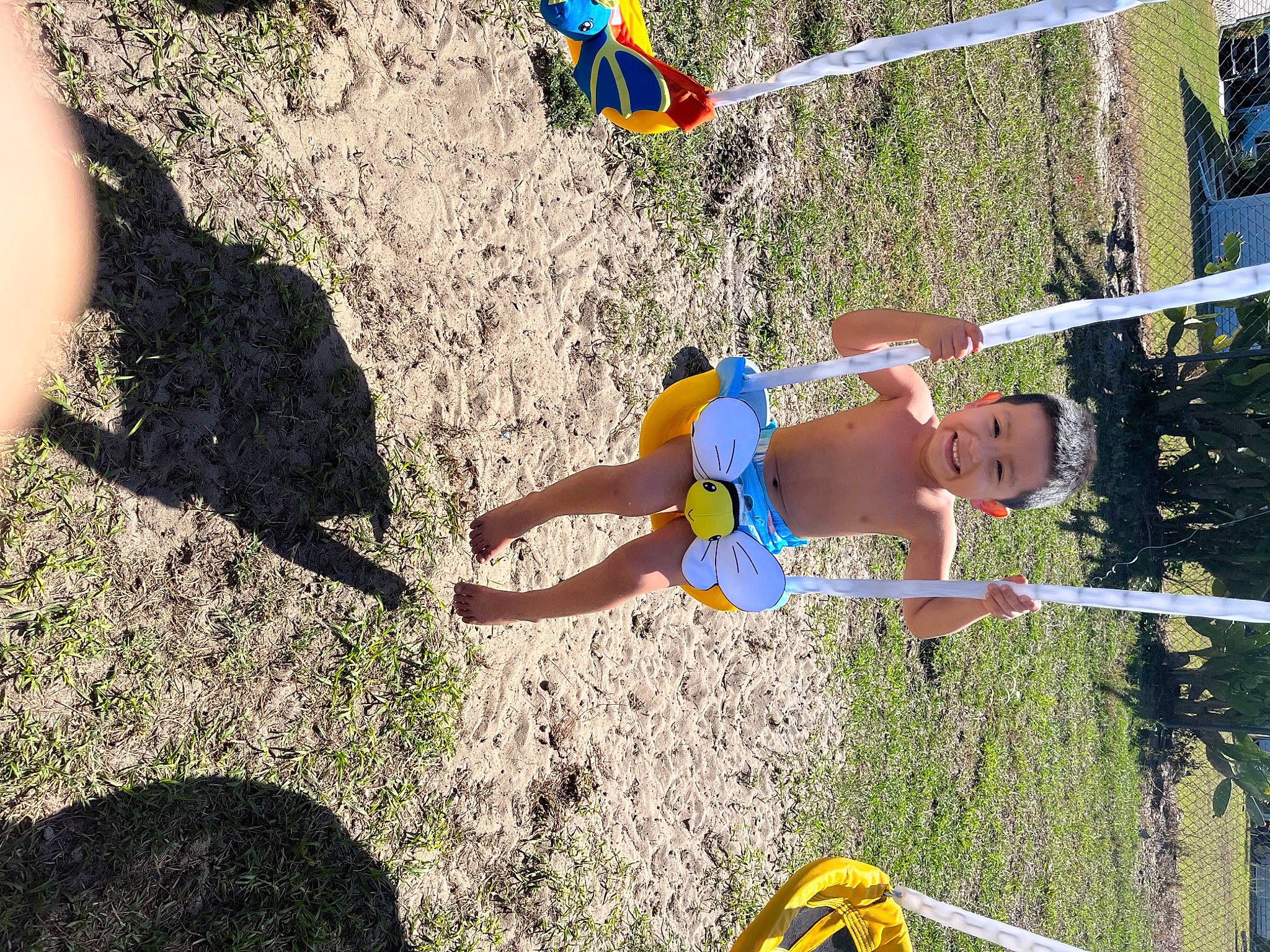 Lorenzo is registered to the contest to win money with this photo: adventure, child, electric_blue, fun, grass, human_leg, joy, landscape, leisure, outdoor_play_equipment, people_in_nature, person, play, recreation, shadow, shorts, soil, swimwear, thigh, toddler