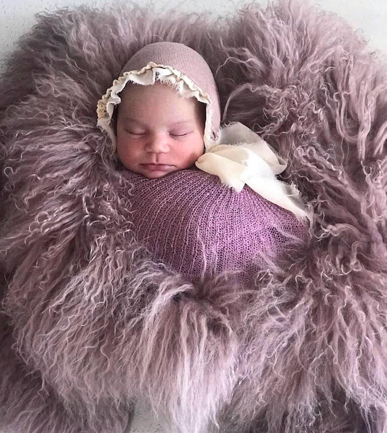 Payton is registered to the contest to win money with this photo: baby, beige, child, child_model, ear, fashion_accessory, fur, fur_clothing, hair_accessory, headgear, headpiece, natural_material, outerwear, person, pink, product, textile, toddler