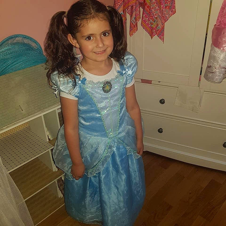 Alanna joined the competition — help win amazing prizes! child, clothing, costume, denim, dress, joy, long_hair, pattern, person, smile, standing, textile, toddler