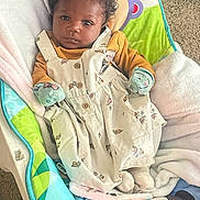Khaleesi joined the competition — help win amazing prizes! baby, infant, child, curly_hair, floral_dress, mittens, baby_chair, blanket, carpet, indoor, portrait, cute, clothing, soft_toys, comfort, seated, looking, face, young_child, cozy
