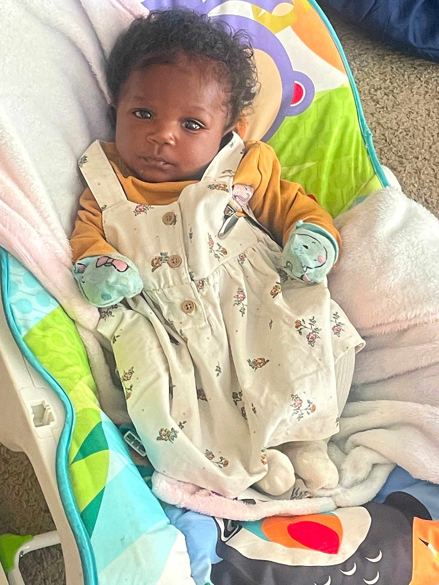 Khaleesi joined the competition — help win amazing prizes! baby, infant, child, curly_hair, floral_dress, mittens, baby_chair, blanket, carpet, indoor, portrait, cute, clothing, soft_toys, comfort, seated, looking, face, young_child, cozy