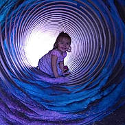 Freya joined the competition — help win amazing prizes! toddler, child, girl, tunnel, crawl, purple, blue, spiral, playground, smile, dress, light, cylindrical, fun, outdoor, happy, curly_hair, play, colorful, young_child
