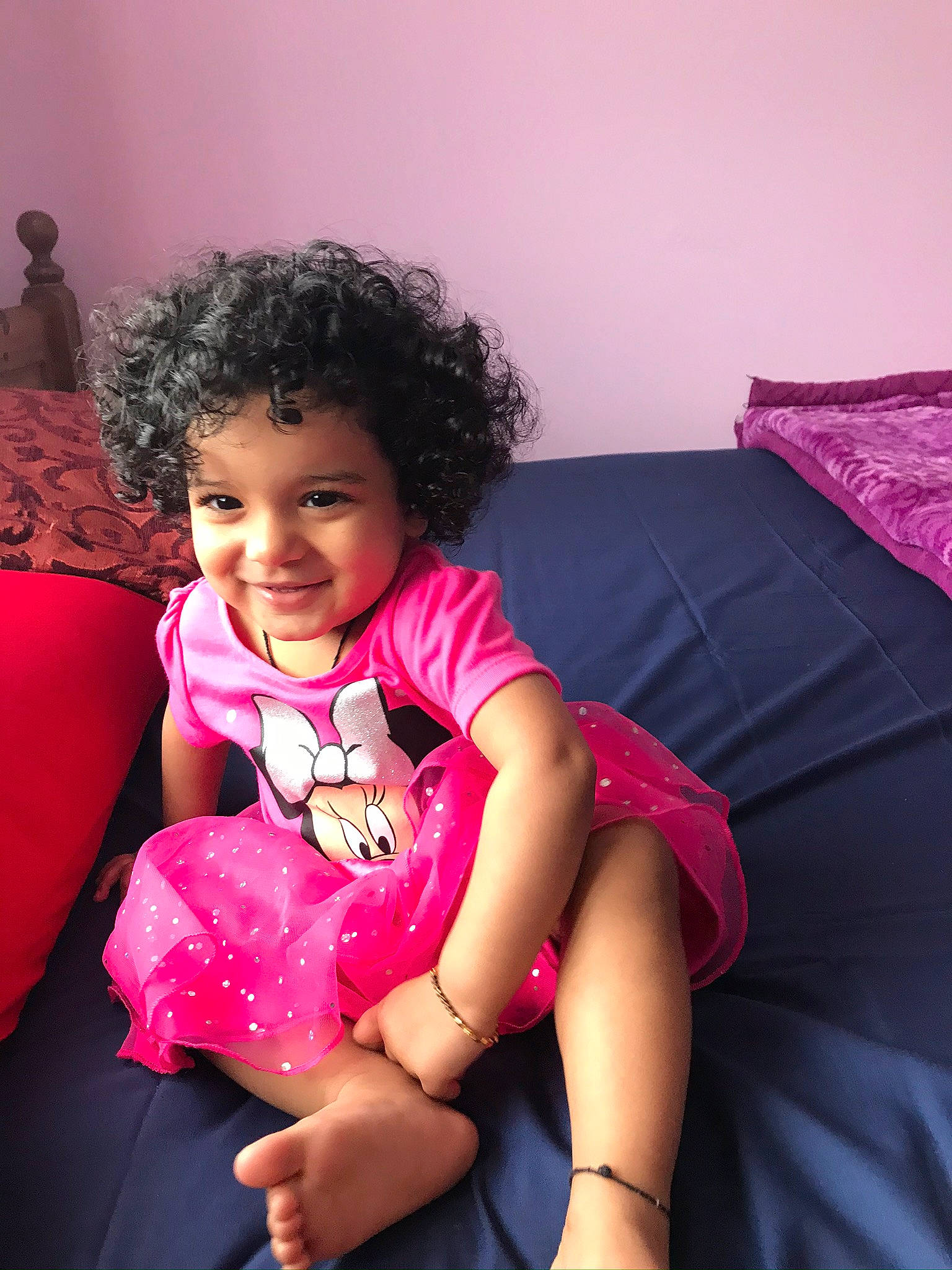 Anishka is registered to the contest to win money with this photo: arm, baby_toddler_clothing, black_hair, comfort, finger, flash_photography, happy, human_body, joint, joy, magenta, mouth, person, pink, purple, shoulder, skin, sleeve, smile, textile