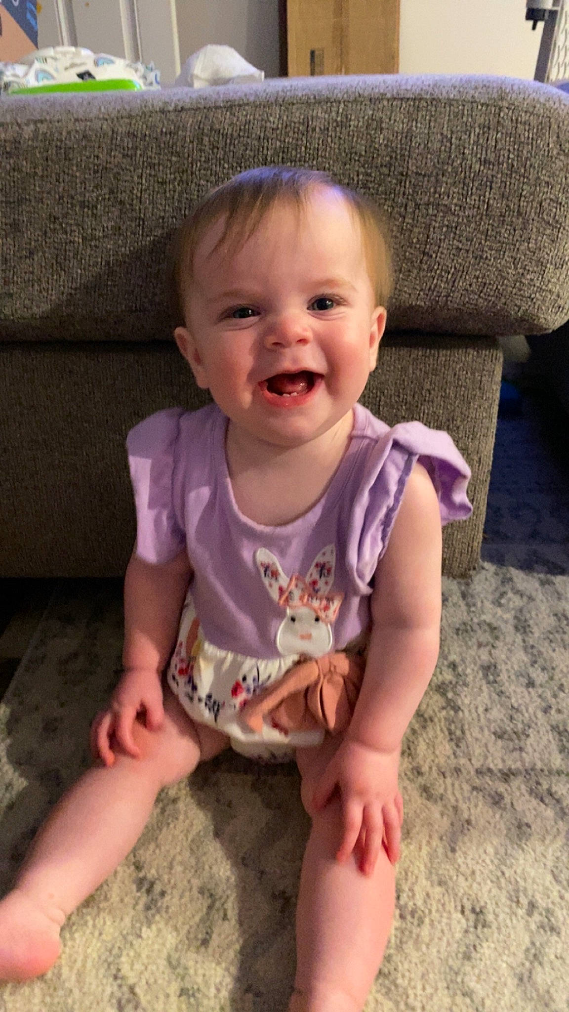 Viviane is registered to the contest to win money with this photo: baby, baby_toddler_clothing, cheek, child, couch, eye, face, finger, fun, grass, happy, head, mouth, person, pink, sitting, skin, sleeve, smile, thumb