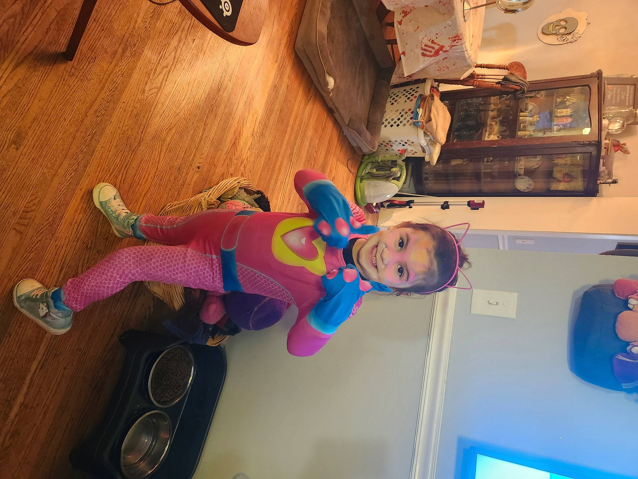 Lyla joined the competition — help win amazing prizes! ceiling, child, electric_blue, flooring, fun, hardwood, house, joy, magenta, mechanical_fan, person, picture_frame, play, room, shelf, shelving, t_shirt, toddler, varnish, wood