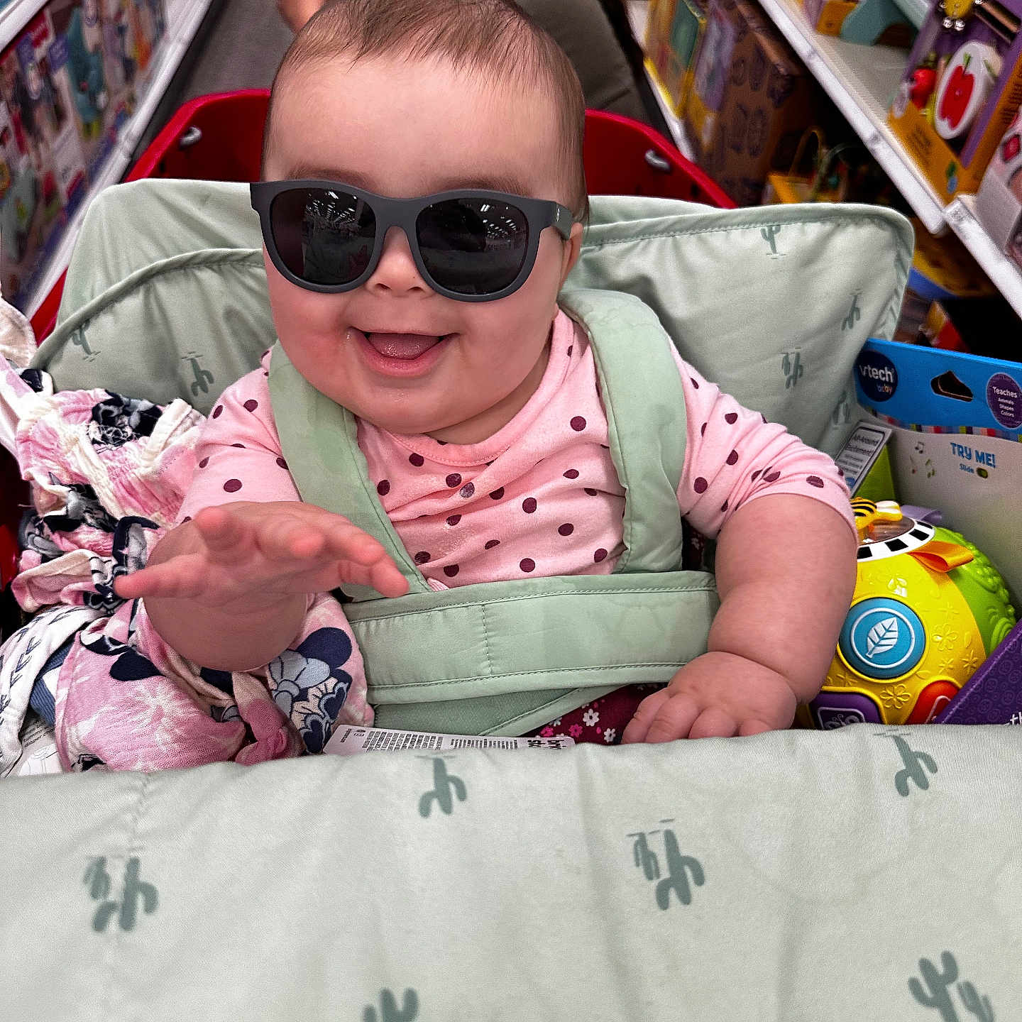 Zevaeh joined the competition — help win amazing prizes! adult, aisle, baby, blanket, child, clothing, face, hair, hand, happy, indoor, person, retail, seat, shopping_cart, smiling, store, sunglasses, toy_aisle, toys