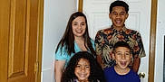 Anniyah is registered to the contest to win money with this photo: adult, blue_shirt, casual_clothing, child, curly_hair, door, family, fun, group, happy, home, indoor, patterned_shirt, people, portrait, posing, short_sleeve, smiling, standing, wooden_door