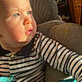 baby, child, blue_eyes, striped_shirt, seated, high_chair, sunlight, indoor, face, cheeks, clothing, person, portrait, infant, furniture, expression, looking_away, soft_light, closeup, cute