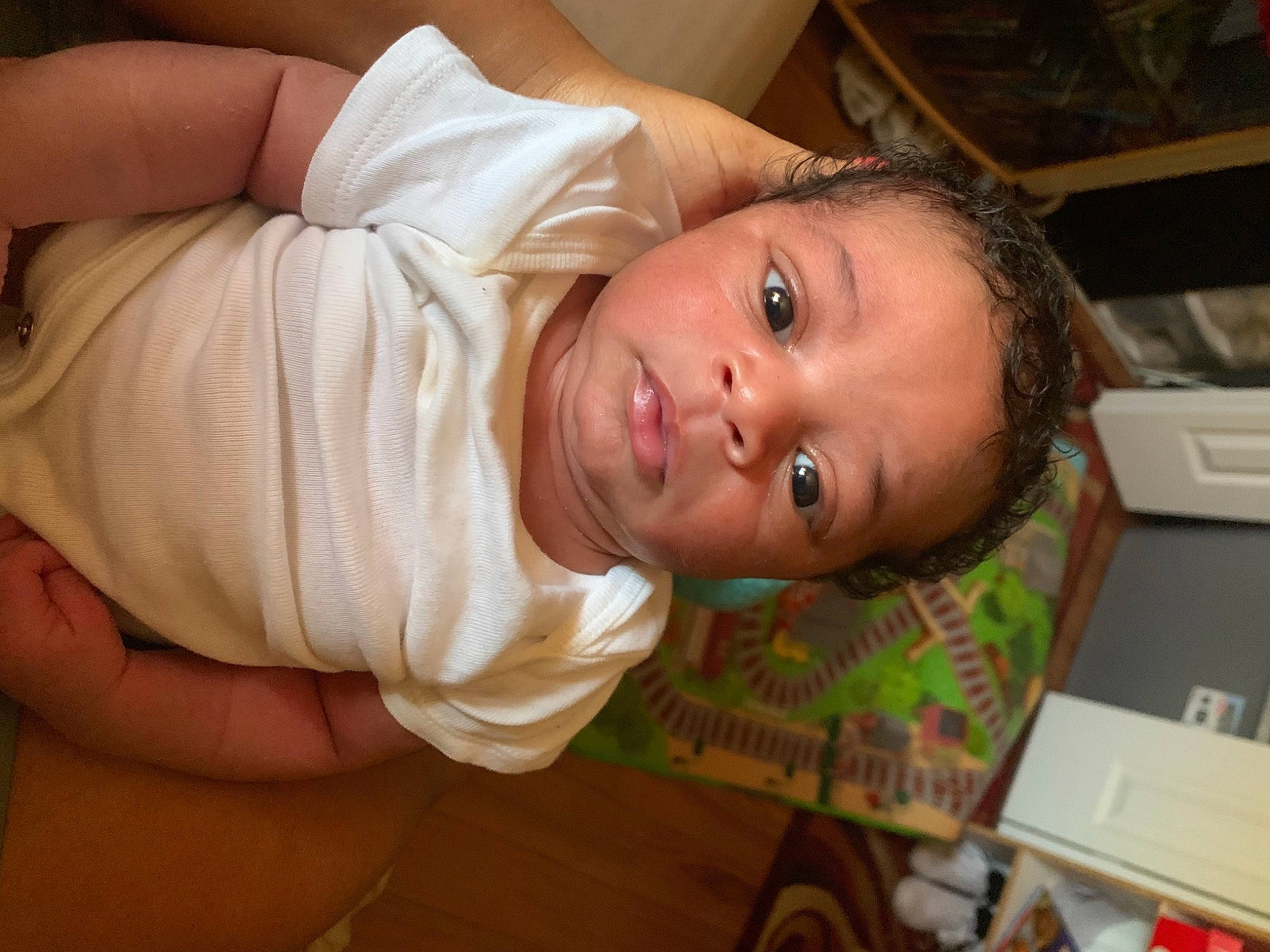 Armoni is registered to the contest to win money with this photo: abdomen, baby, baby_toddler_clothing, cheek, chest, child, comfort, elbow, flooring, fun, happy, hardwood, hat, iris, nose, person, room, sitting, skin, toddler