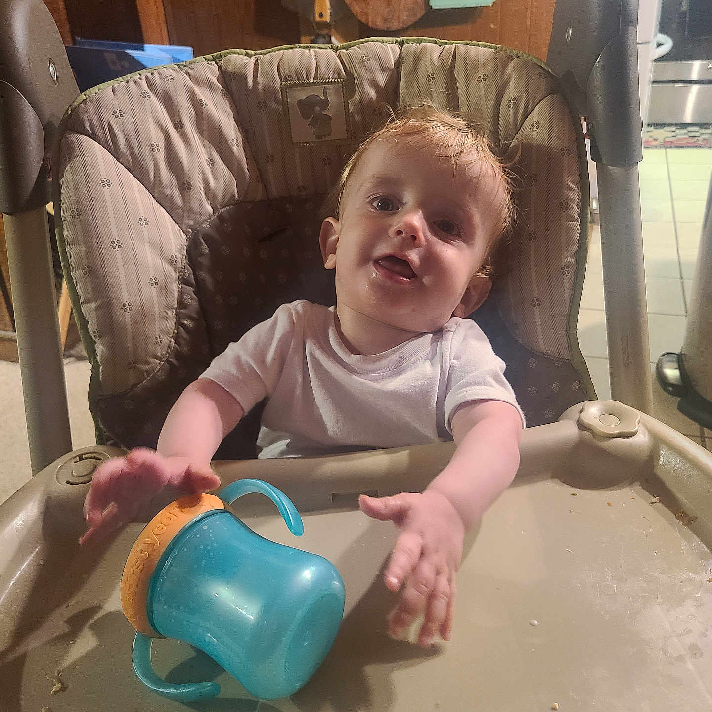 Rome is registered to the contest to win money with this photo: baby, beverage, bodypart, bottle, chair, coffee, coffeecup, crib, cup, face, finger, furniture, hand, head, infantbed, jug, person, photography, portrait, shaker