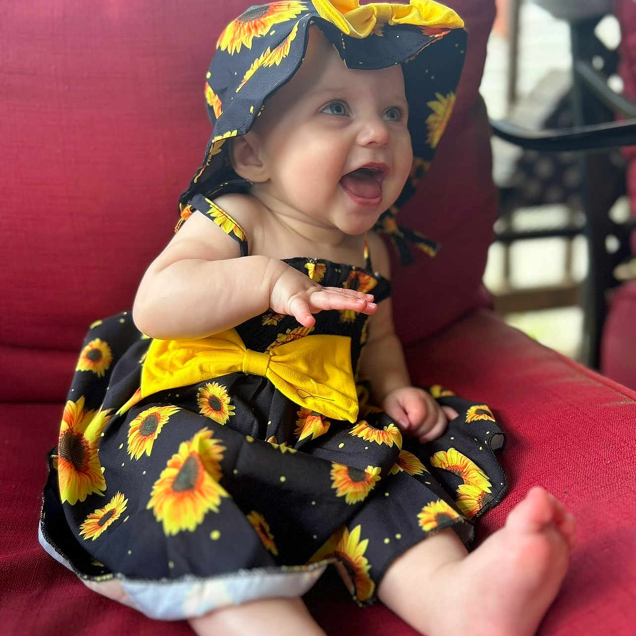 Kinsley joined the competition — help win amazing prizes! baby, bodypart, bonnet, clothing, costume, couch, cushion, cutlery, dress, face, finger, furniture, hand, hat, head, person, photography, portrait, sitting, spoon