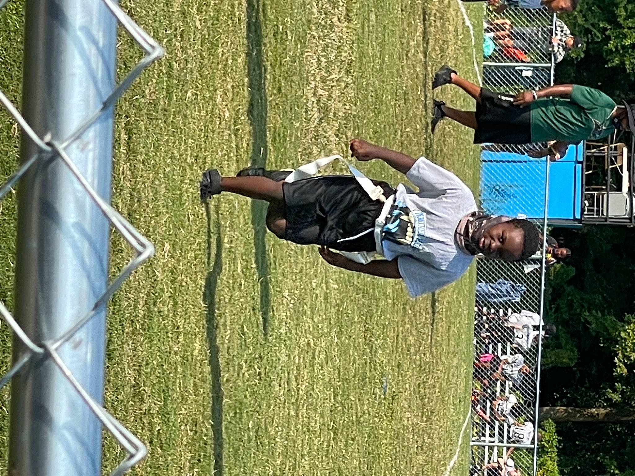 Terrence is registered to the contest to win money with this photo: acrobatics, adventure, competition, competition_event, extreme_sport, fun, grass, leisure, mesh, net, outdoor_play_equipment, person, plant, player, recreation, rope, sports, stunt, t_shirt, team_sport